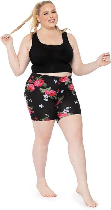 Model showcasing bike shorts with a floral pattern.