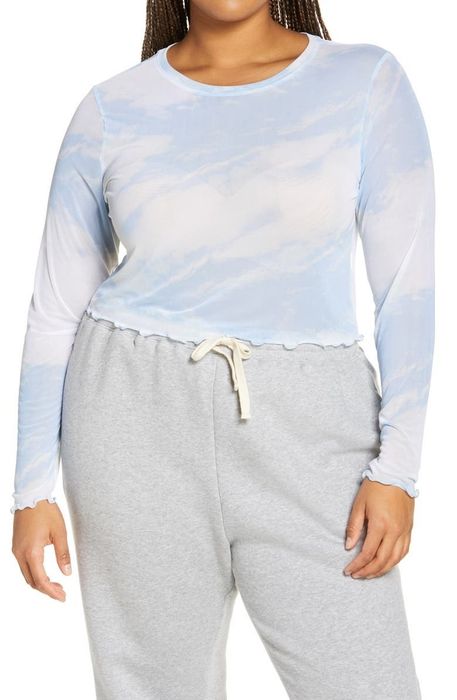 A model wearing the blue and white mesh top