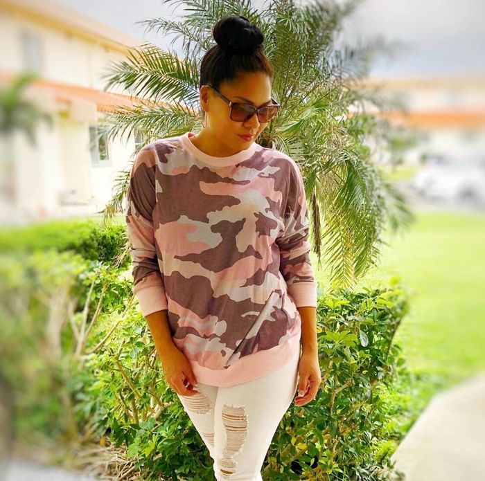 A reviewer wearing the pink sweatshirt