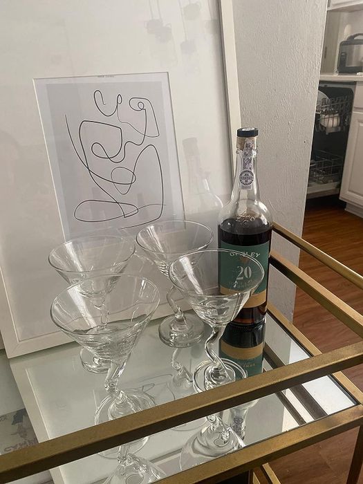 A reviewer displays the set on a gold bar cart
