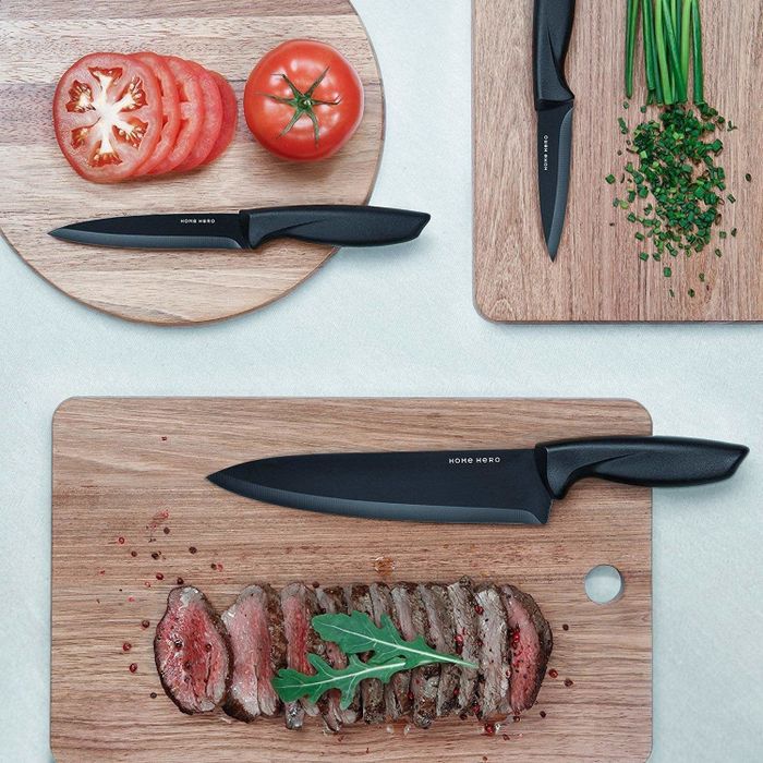 The chef's knife and two paring knives displayed on cutting boards