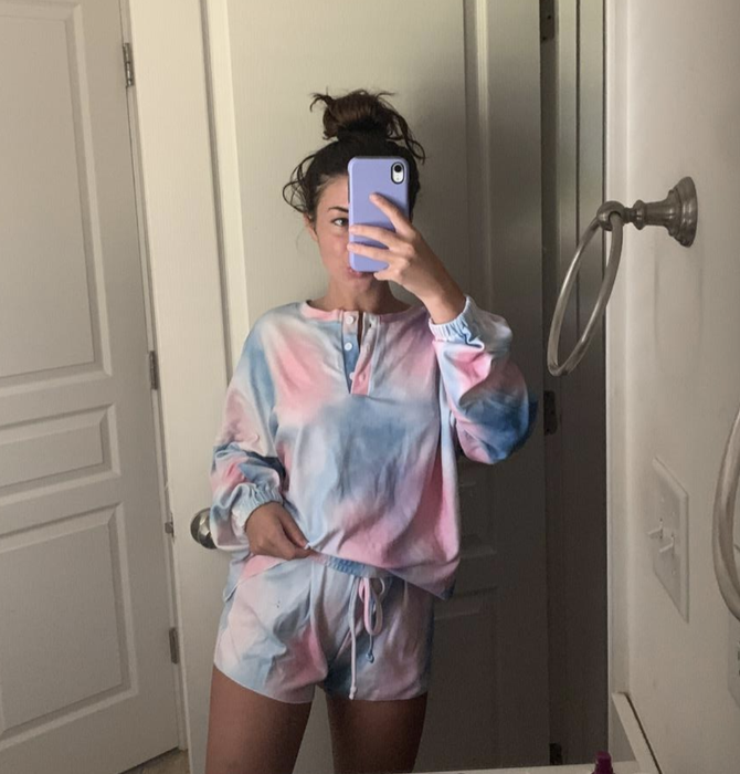 The reviewer is dressed in a tie-dye set.