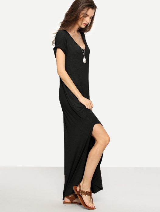 Model showing off the dress, featuring short sleeves, a scoop neck, and a stylish slit