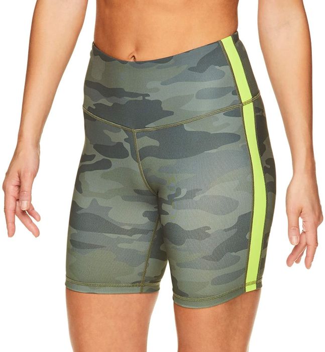 A model is wearing green camouflage Reebok bike shorts.