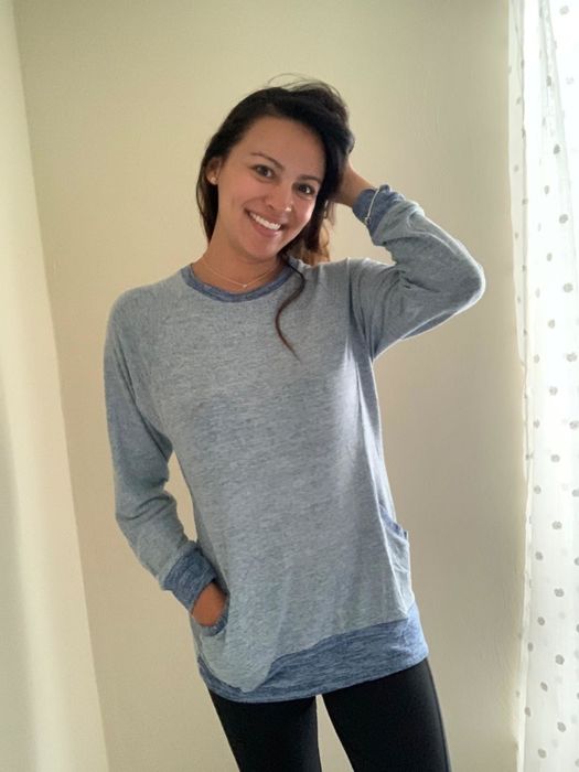 A reviewer wearing the blue sweatshirt