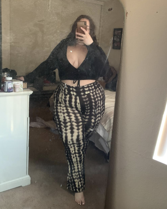 A reviewer shows off black and white tie-dye pants.