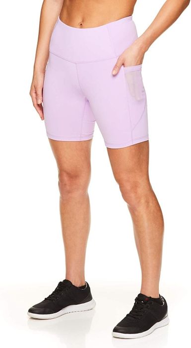 A model is showcasing pink Reebok bike shorts.