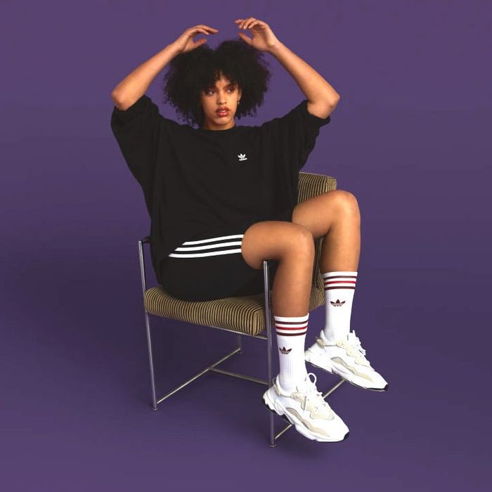 Model styled in a black sweatshirt paired with matching bike shorts and white socks pulled up high