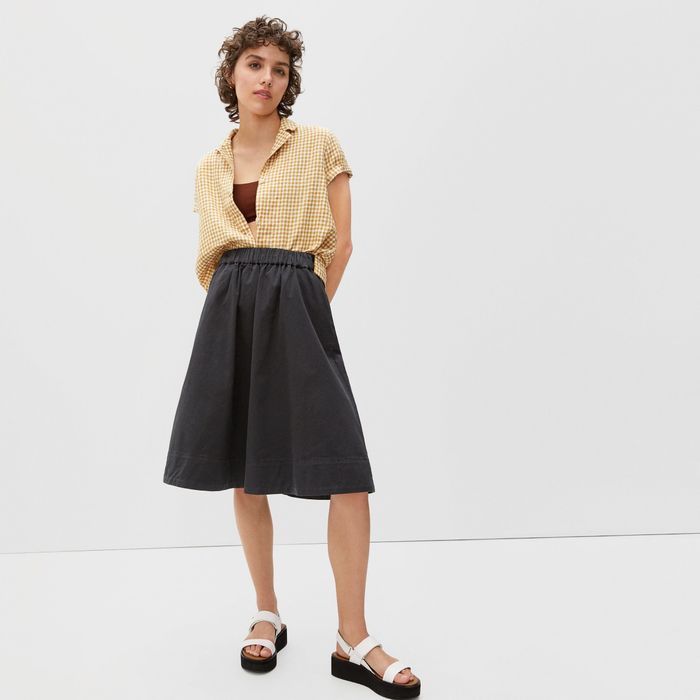 A model dons the sleek black knee-length skirt