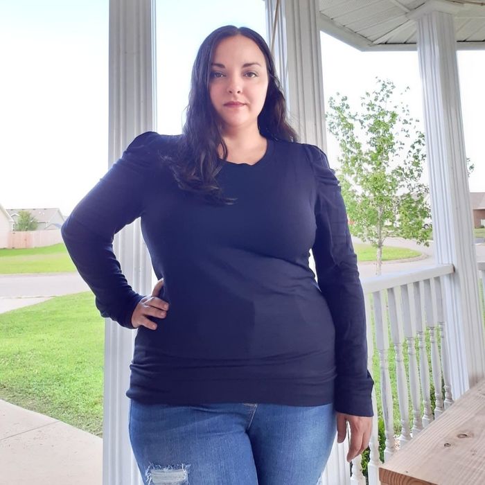 A reviewer styling the black version of the shirt