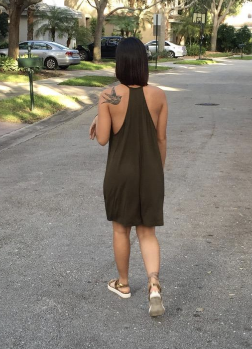 The reviewer is dressed in a racerback dress.