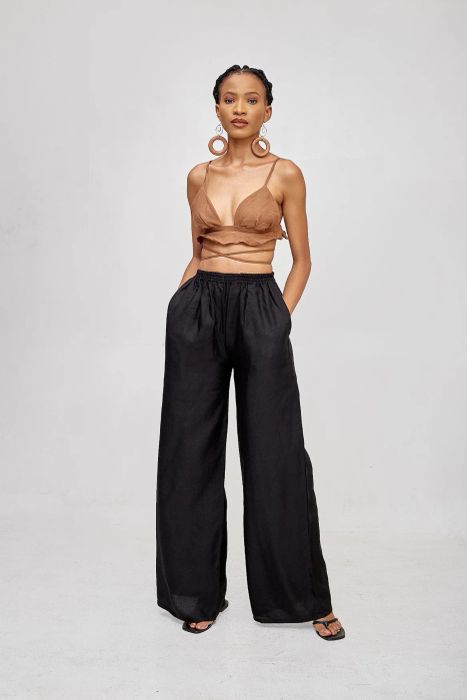 A reviewer showcasing the maxi dress, highlighting the thigh-high slit