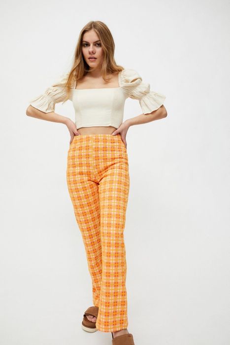 A model rocking the orange plaid pants.