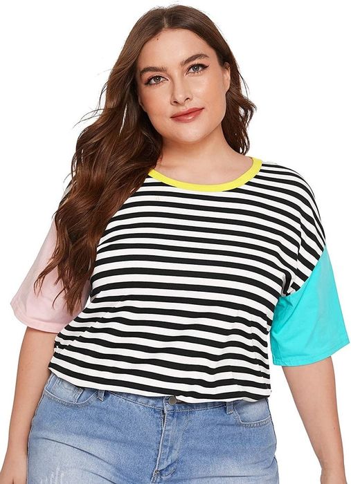 Model sporting a black and white striped tee with pink and blue sleeves