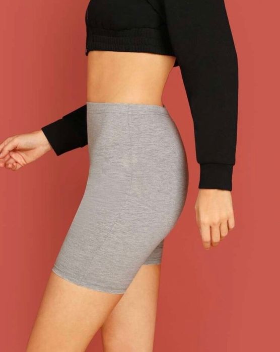A model is showing the side view of cotton bike shorts.