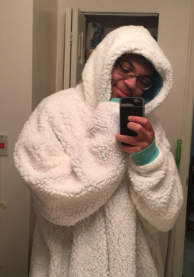 A reviewer modeling the cozy white blanket sweatshirt