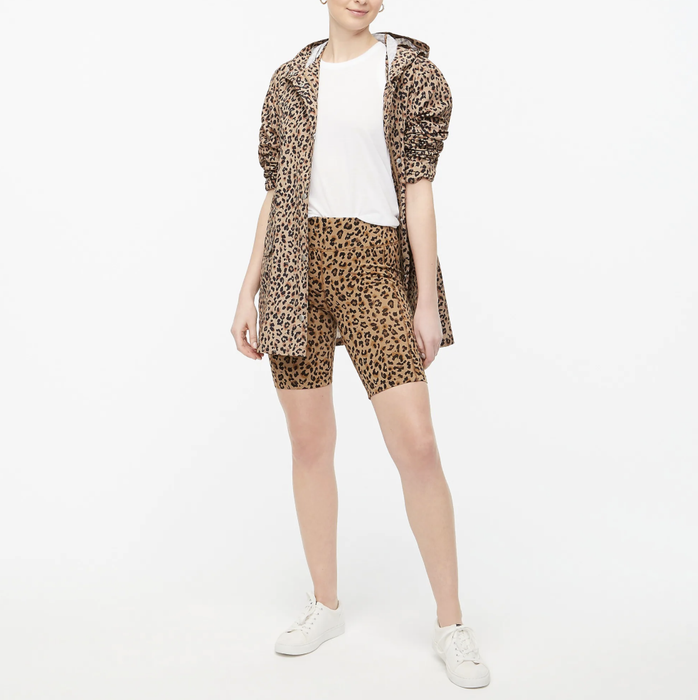 A model is wearing leopard print biker shorts.