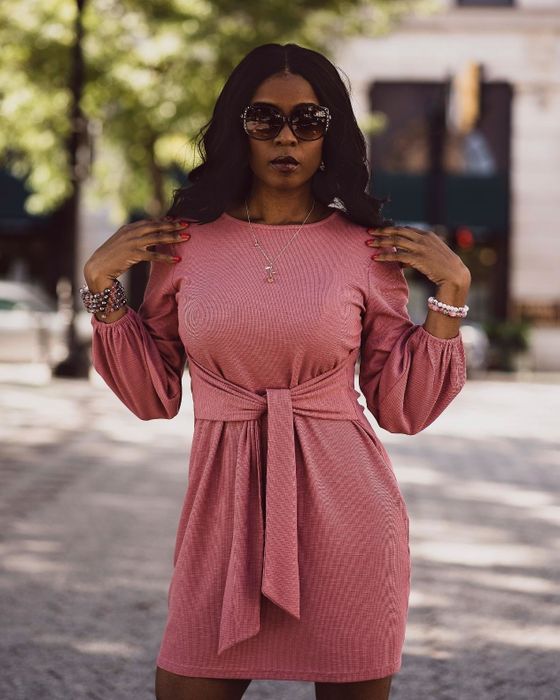 A reviewer wearing the pink dress