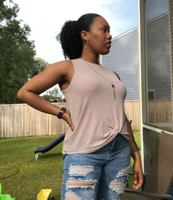 A reviewer rocking the oatmeal-colored tank