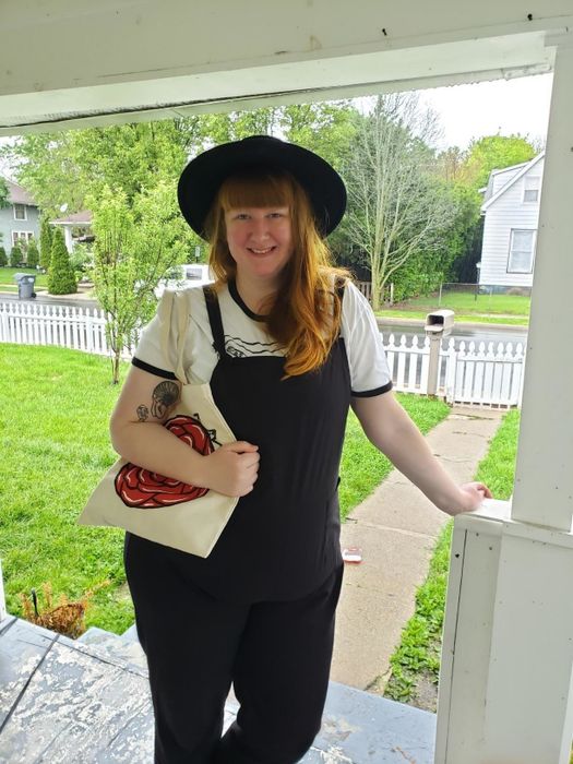 A reviewer photo of a plus-size customer wearing the black Aedvoouer Women's Jumpsuit on a front porch