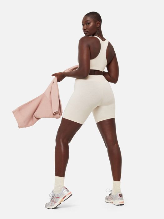 A model wearing white Mate shorts, showcasing a fresh, clean look.