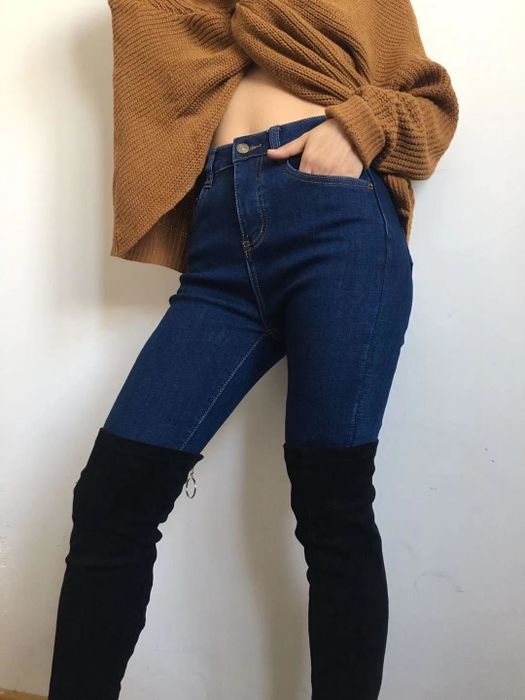 A reviewer showcasing the dark wash jeggings