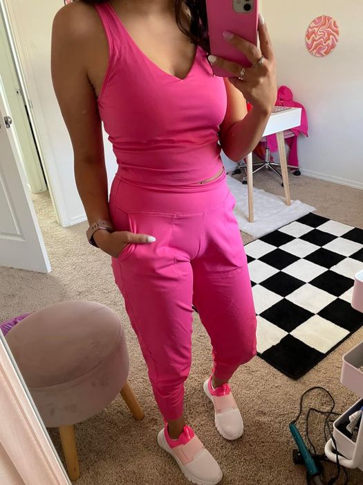 A reviewer showcasing pink jogger pants