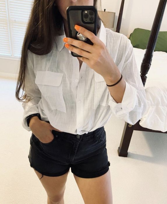 A person wearing the top fully buttoned