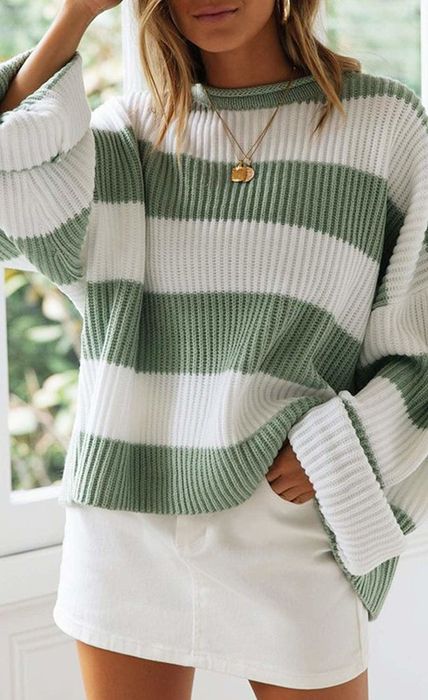 An oversized striped sweater featuring green and white stripes.