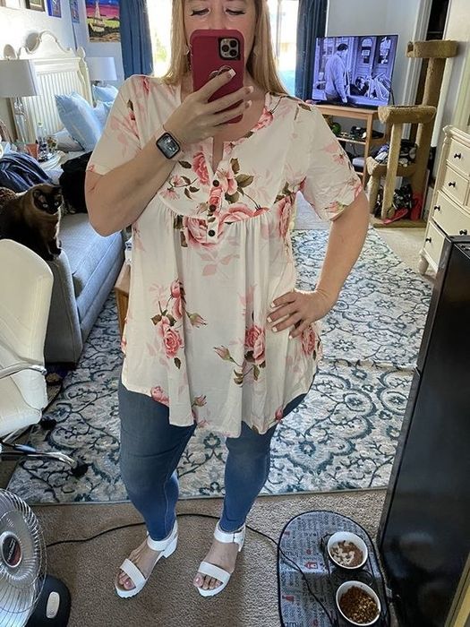 A person modeling a floral blouse