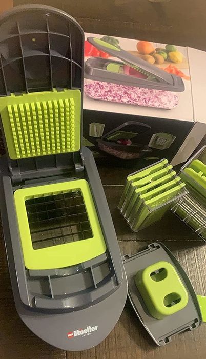 A reviewer's photo of the chopping unit alongside its various interchangeable blades