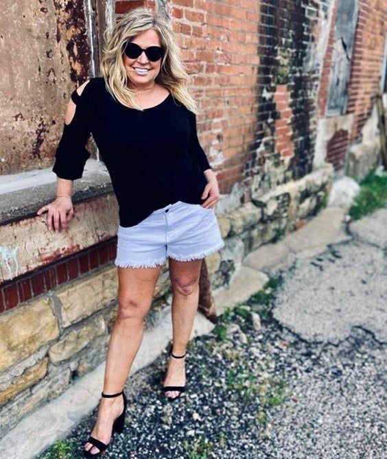 A reviewer wearing the top in black