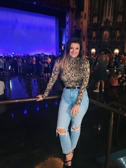 A reviewer modeling the leopard print bodysuit