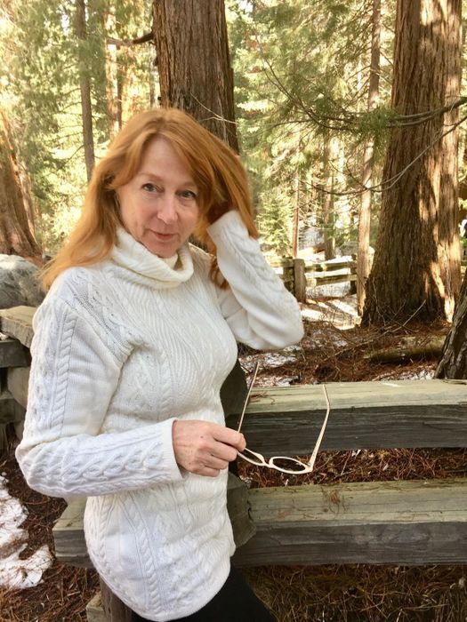 Another reviewer is wearing the same sweater, but this close-up shot highlights the beautiful cable-knit pattern