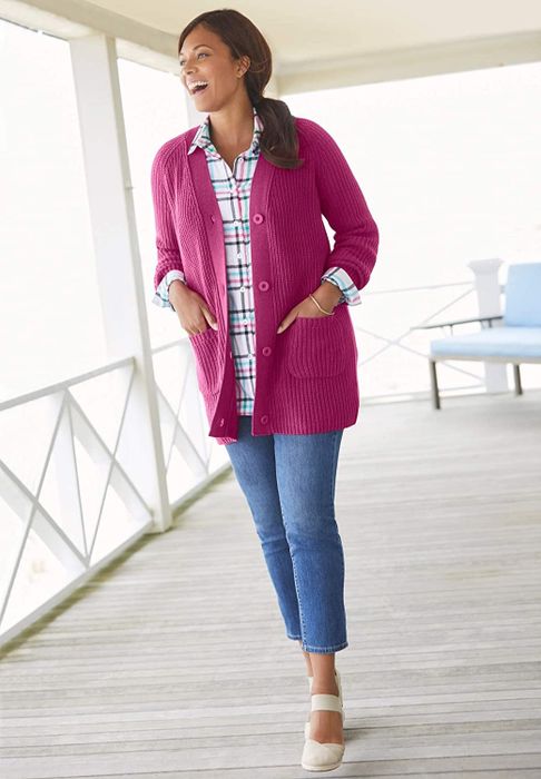 A model is wearing the button-down cardigan in a soft pink shade.