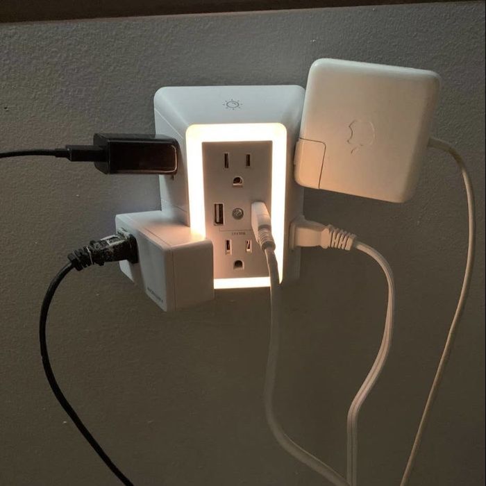 A charger with multiple large plugs inserted into it