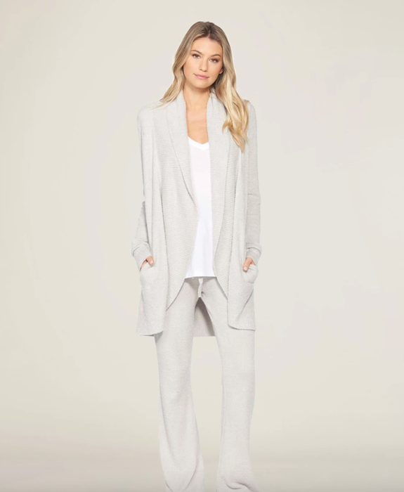 A model showing off the light grey rounded cardigan