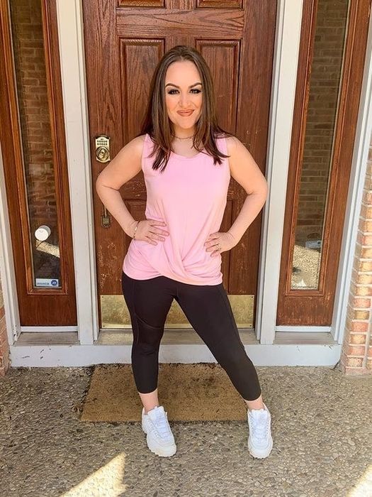 A reviewer showcasing the twist top in a pink hue