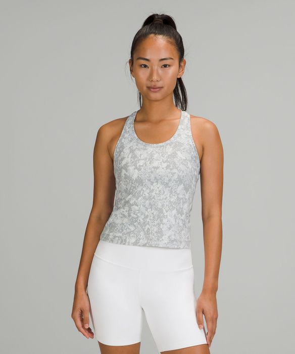 a model showcasing the top in a stylish gray and white pattern