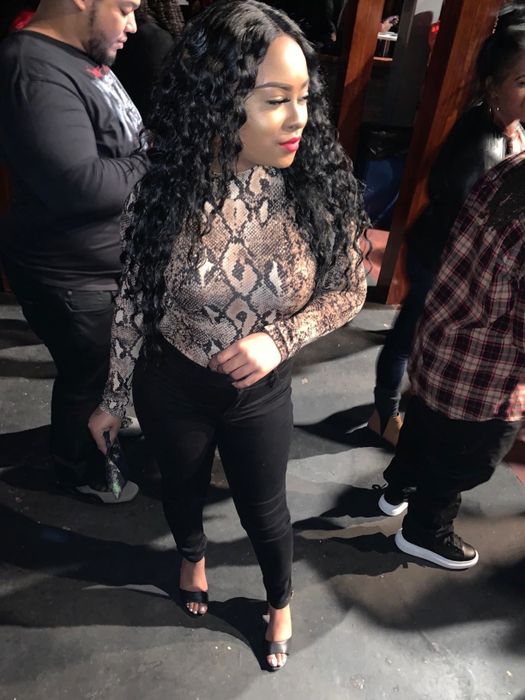 A reviewer wearing the snake print bodysuit