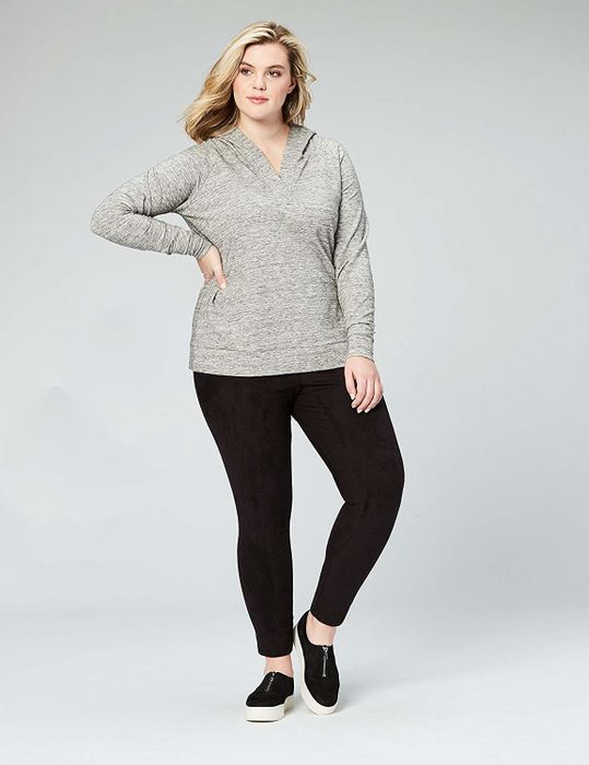 A model wearing a sweatshirt featuring a kangaroo pouch