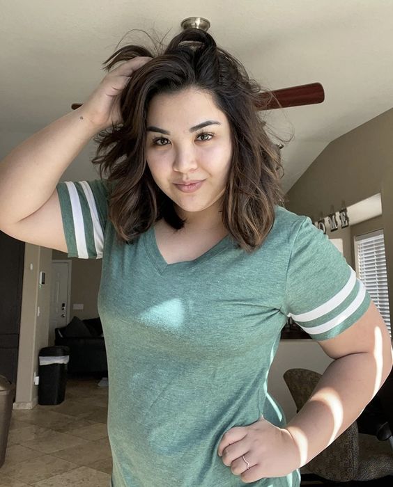 a model showcasing the green varsity shirt