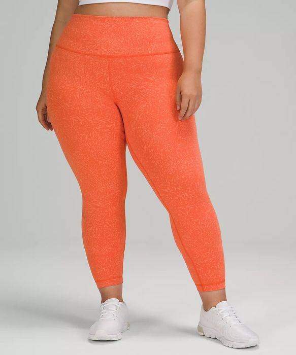 A model wearing the orange leggings.