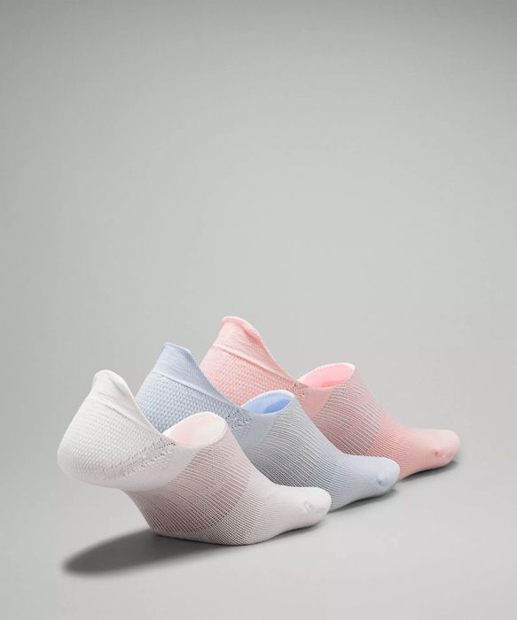 Four pairs of ankle socks are presented in different colors: white, light blue, light pink, and gray. This image highlights the variety of color options that are available for purchase.