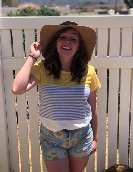 A reviewer showcasing the vibrant yellow shirt