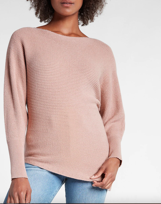 A model is showcasing the boat-neck sweater in a light pink shade.