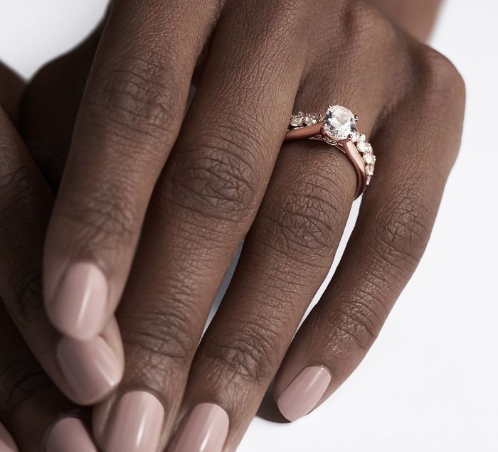 model wearing the diamond ring paired with a rose gold band