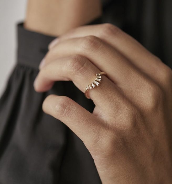 the model wearing the elegantly curved baguette ring