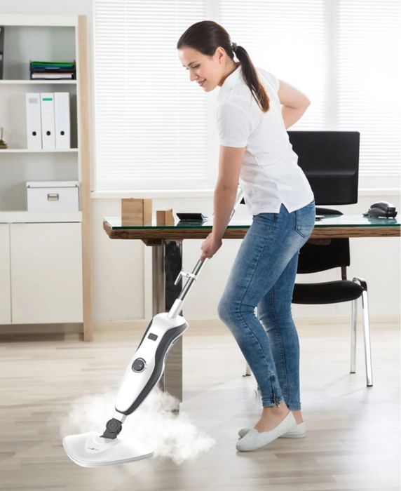 A model using a steam mop to efficiently clean the floor, showing off its effectiveness and ease of use.