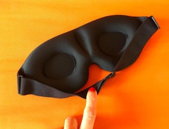 The back of a sleep mask featuring contoured cups that gently cradle your eyes, enhancing comfort during sleep.